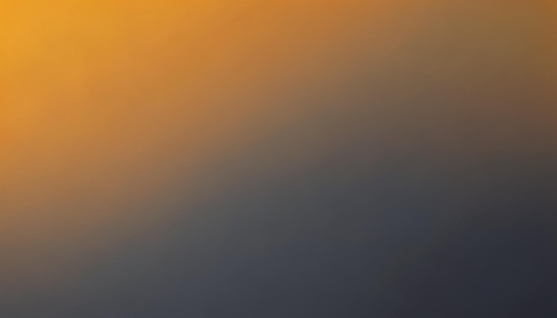 Warm amber and slate gray abstract gradient suggesting a quiet, professional workspace